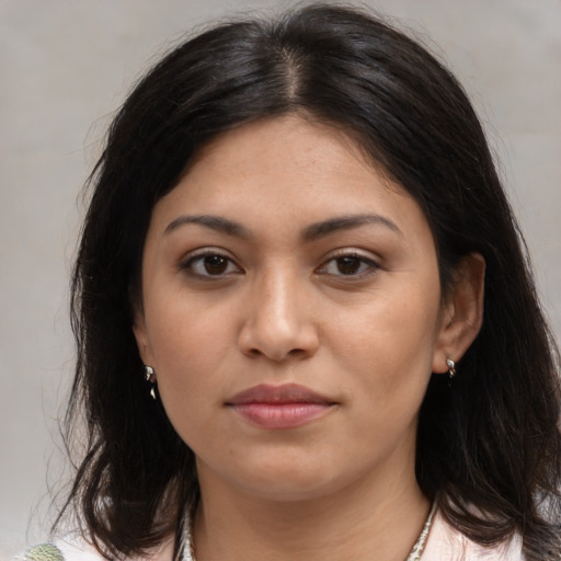 Joyful latino young-adult female with medium  brown hair and brown eyes