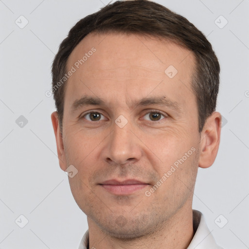 Joyful white adult male with short  brown hair and brown eyes