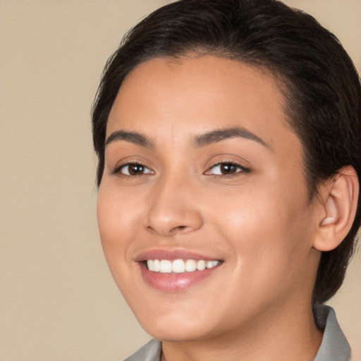 Joyful white young-adult female with medium  brown hair and brown eyes