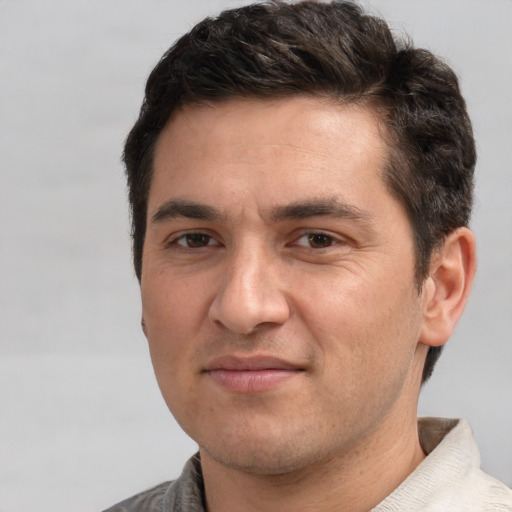 Joyful white adult male with short  brown hair and brown eyes