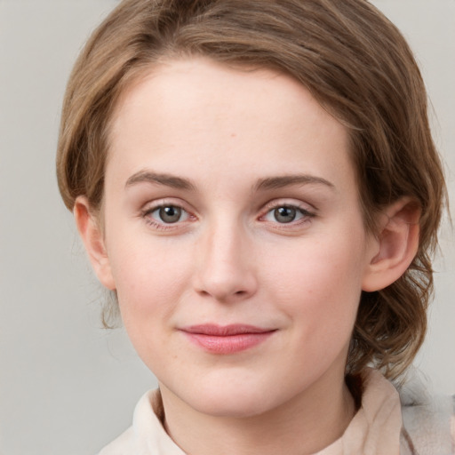 Joyful white young-adult female with medium  brown hair and green eyes