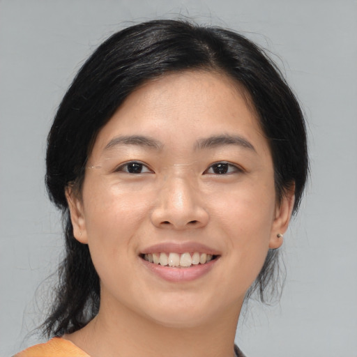 Joyful asian young-adult female with medium  black hair and brown eyes