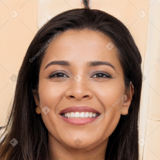 Joyful latino young-adult female with long  brown hair and brown eyes