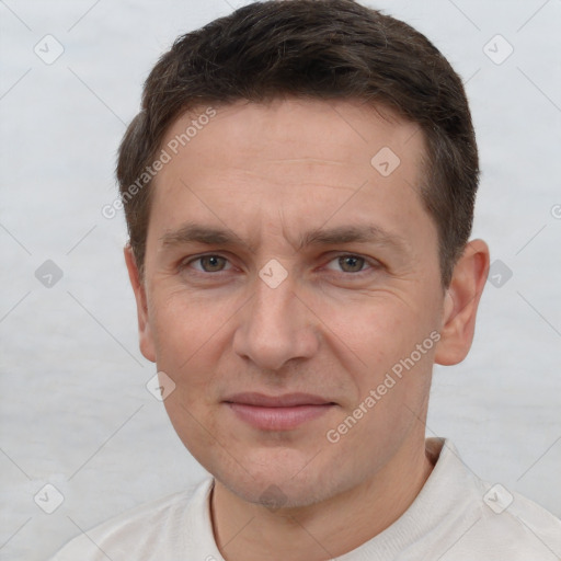 Joyful white adult male with short  brown hair and brown eyes