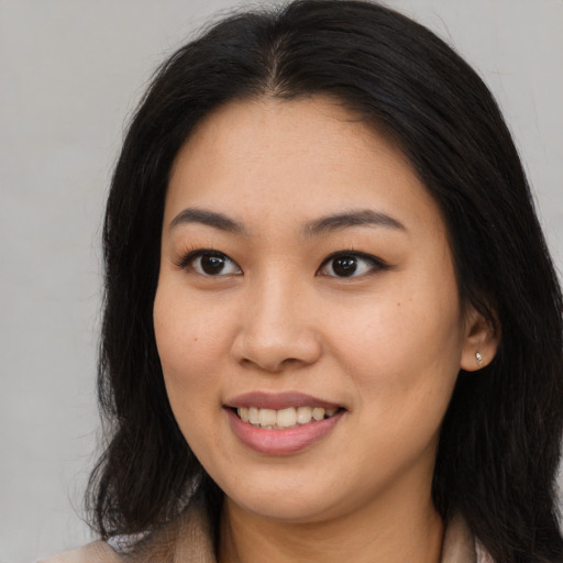 Joyful asian young-adult female with long  brown hair and brown eyes