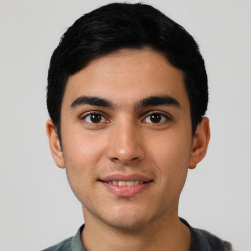 Joyful latino young-adult male with short  black hair and brown eyes