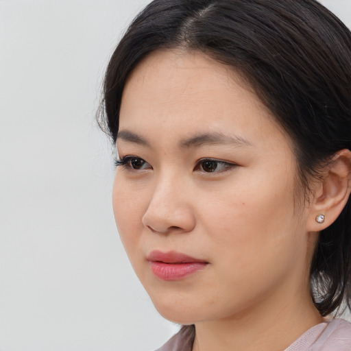 Neutral asian young-adult female with medium  brown hair and brown eyes