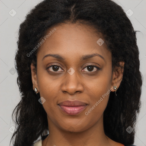 Joyful black young-adult female with long  brown hair and brown eyes