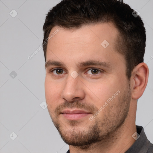 Joyful white young-adult male with short  brown hair and brown eyes