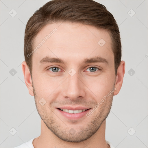 Joyful white young-adult male with short  brown hair and grey eyes