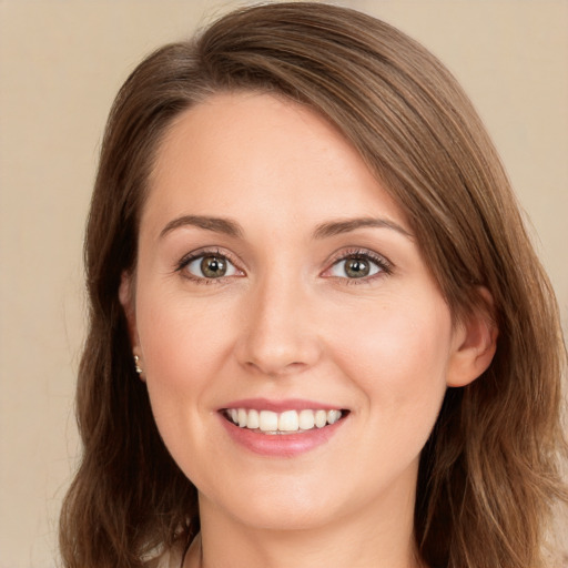 Joyful white young-adult female with long  brown hair and green eyes