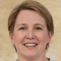 Joyful white adult female with medium  brown hair and brown eyes