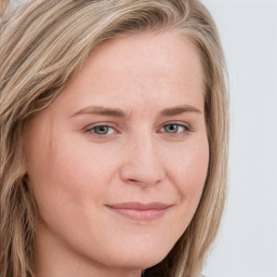 Joyful white young-adult female with long  brown hair and blue eyes