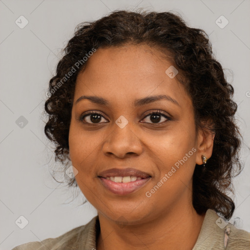 Joyful black young-adult female with long  brown hair and brown eyes