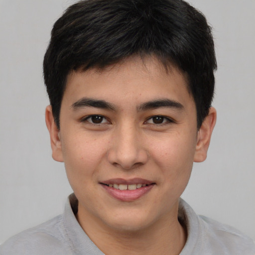 Joyful asian young-adult male with short  brown hair and brown eyes