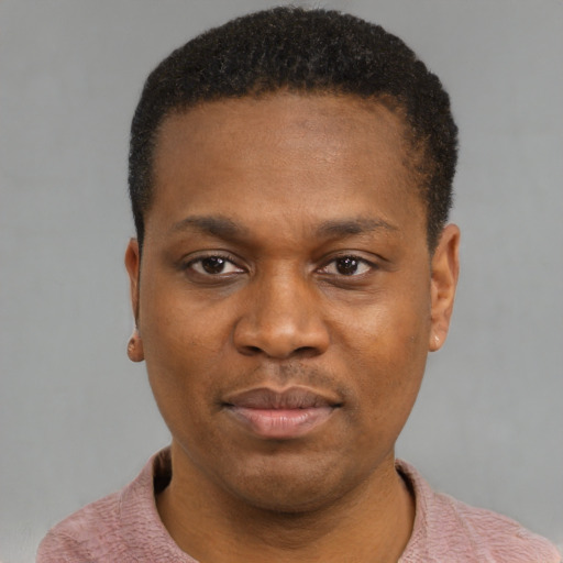 Joyful black young-adult male with short  black hair and brown eyes