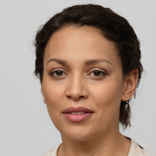 Joyful white adult female with short  brown hair and brown eyes