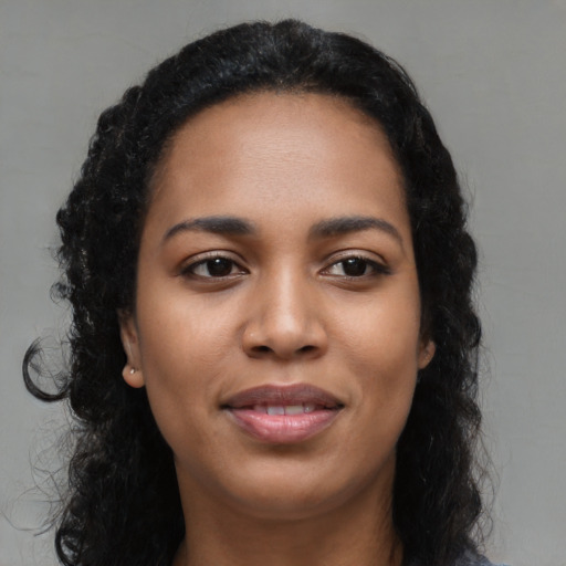 Joyful latino young-adult female with long  black hair and brown eyes