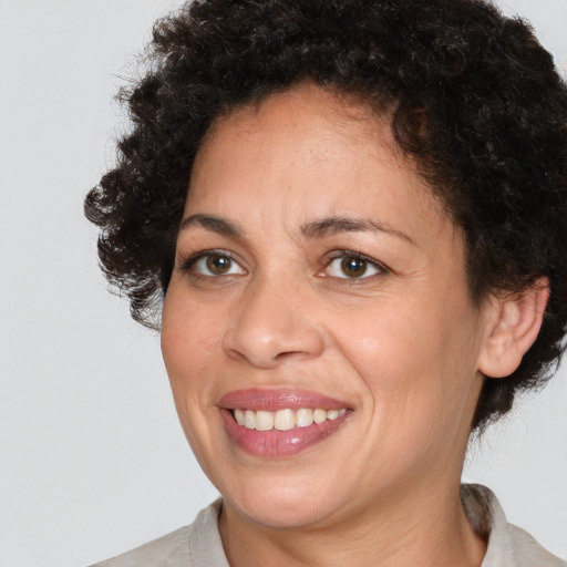 Joyful black adult female with medium  brown hair and brown eyes
