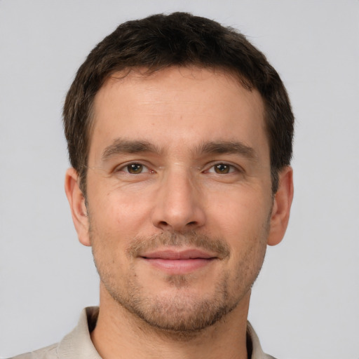 Joyful white young-adult male with short  brown hair and brown eyes