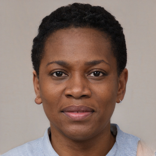 Joyful black young-adult female with short  black hair and brown eyes