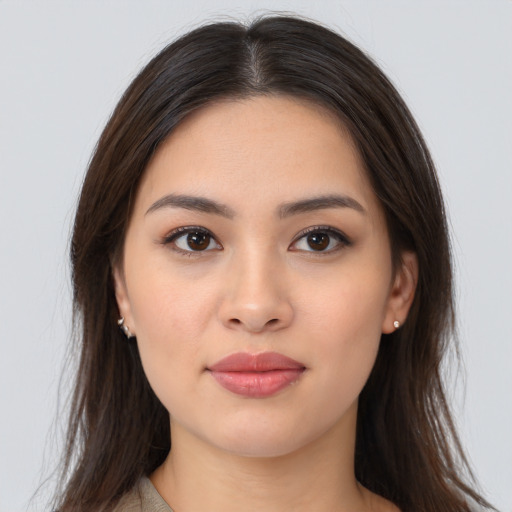 Joyful asian young-adult female with long  brown hair and brown eyes