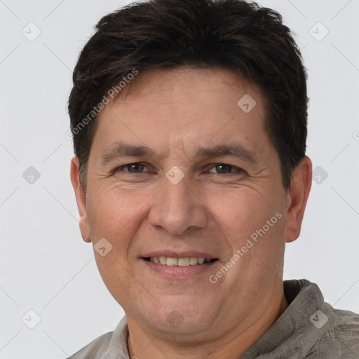 Joyful white adult male with short  brown hair and brown eyes