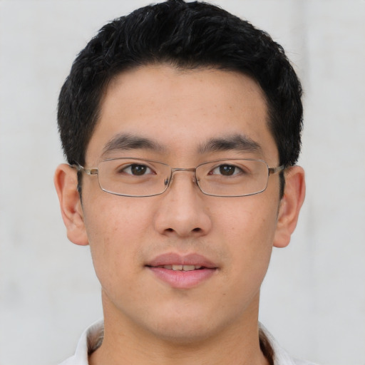 Joyful asian young-adult male with short  brown hair and brown eyes