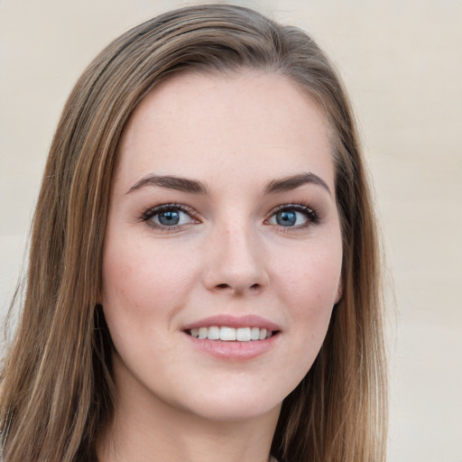 Joyful white young-adult female with long  brown hair and grey eyes