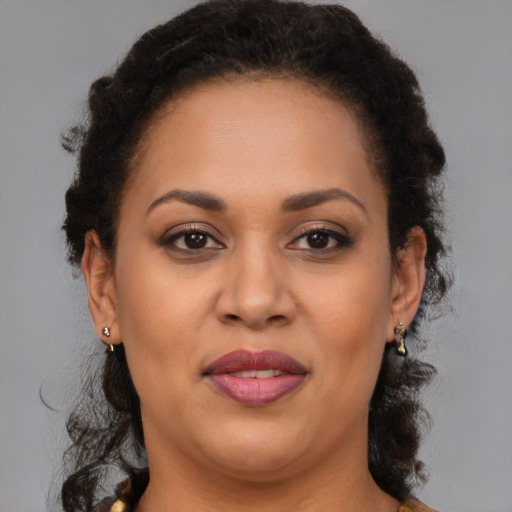 Joyful latino adult female with medium  brown hair and brown eyes