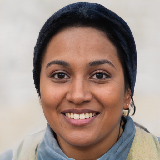 Joyful latino young-adult female with short  black hair and brown eyes