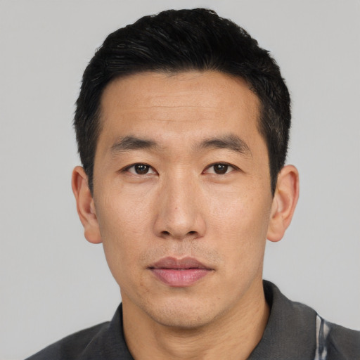 Neutral asian adult male with short  black hair and brown eyes