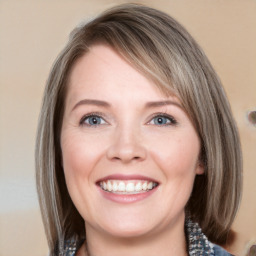 Joyful white young-adult female with medium  brown hair and blue eyes