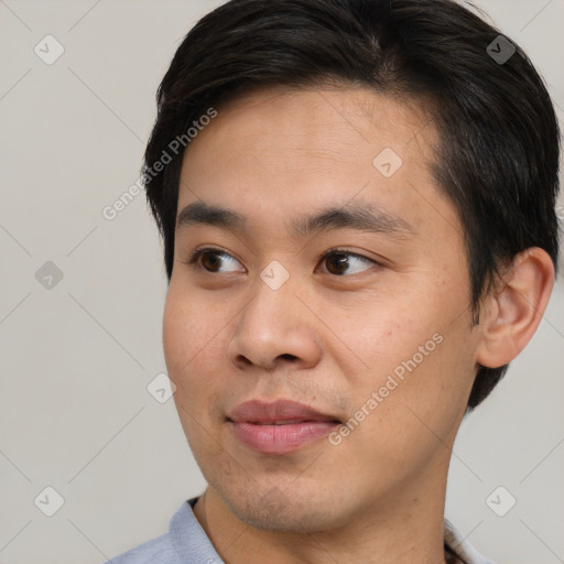 Joyful asian young-adult male with short  brown hair and brown eyes