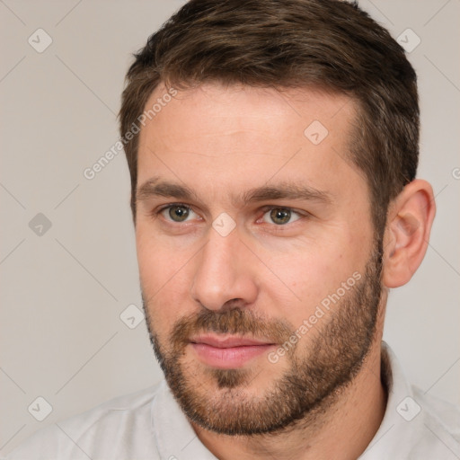 Joyful white young-adult male with short  brown hair and brown eyes