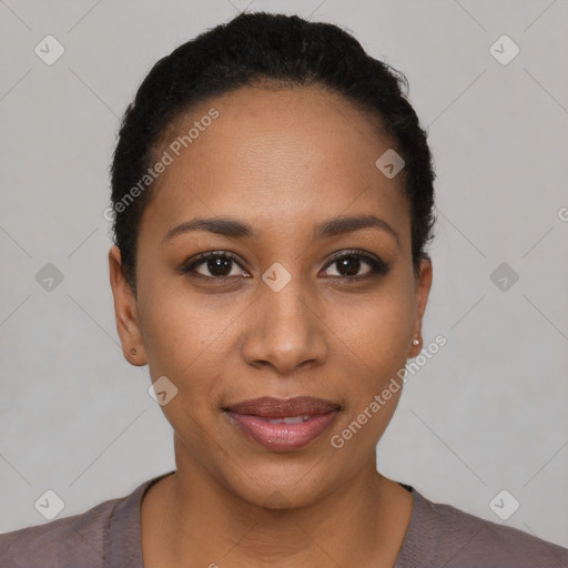 Joyful black young-adult female with short  black hair and brown eyes