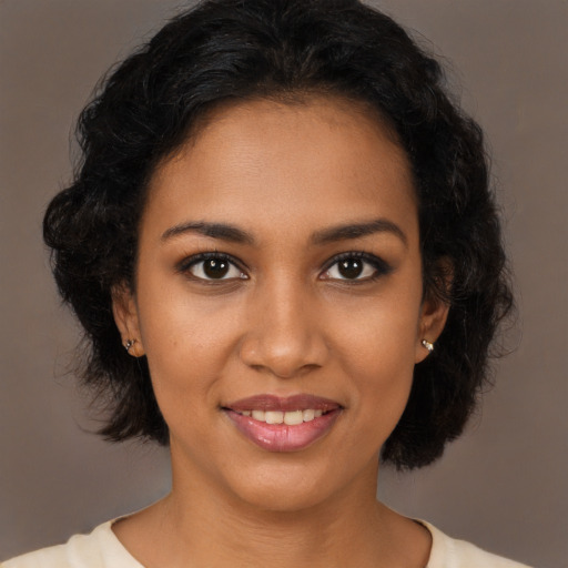 Joyful black young-adult female with medium  brown hair and brown eyes