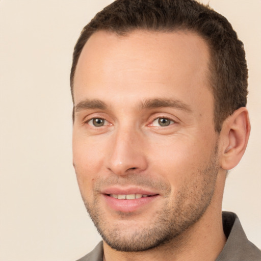 Joyful white young-adult male with short  brown hair and brown eyes