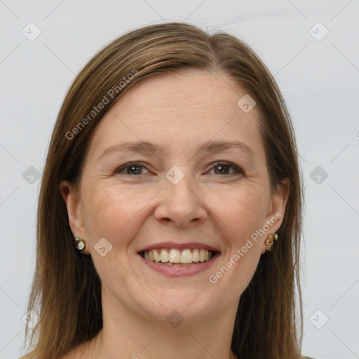 Joyful white adult female with long  brown hair and grey eyes