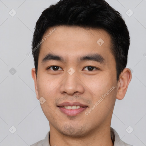 Joyful asian young-adult male with short  black hair and brown eyes