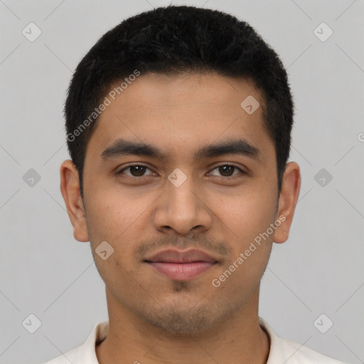 Joyful latino young-adult male with short  black hair and brown eyes