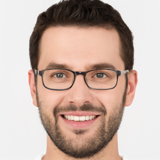 Joyful white young-adult male with short  brown hair and brown eyes