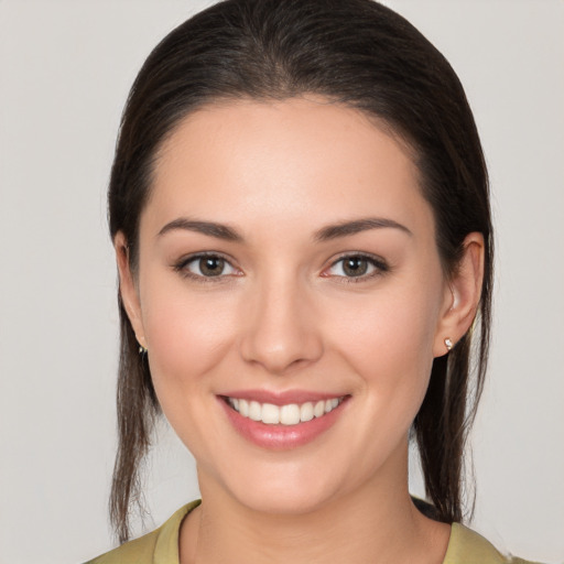 Joyful white young-adult female with medium  brown hair and brown eyes