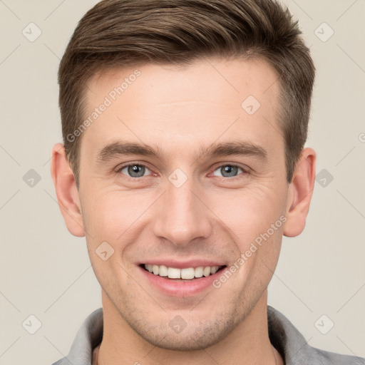 Joyful white young-adult male with short  brown hair and grey eyes