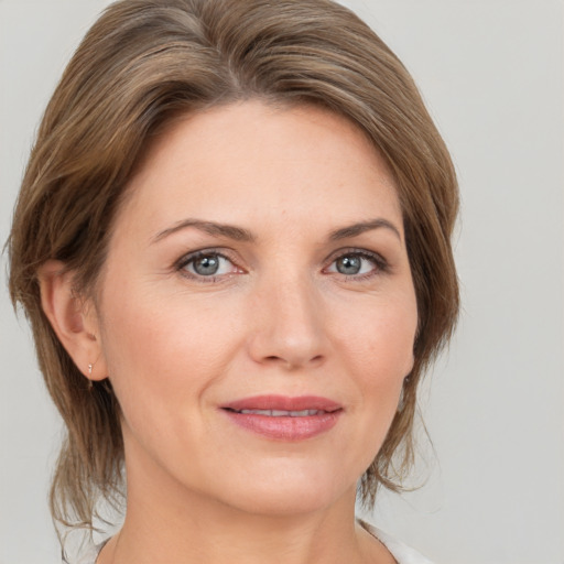 Joyful white adult female with medium  brown hair and brown eyes