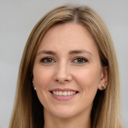 Joyful white young-adult female with long  brown hair and brown eyes