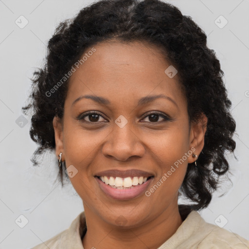 Joyful black adult female with long  brown hair and brown eyes