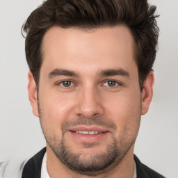 Joyful white young-adult male with short  brown hair and brown eyes