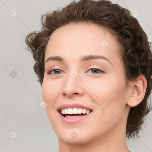 Joyful white young-adult female with medium  brown hair and green eyes