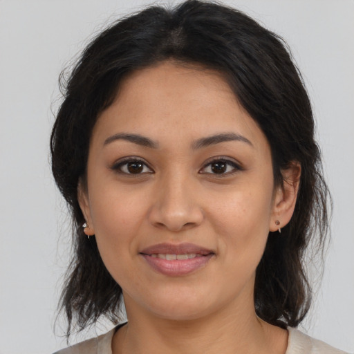 Joyful latino young-adult female with medium  brown hair and brown eyes